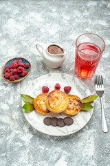 front view delicious muffins with honey and choco biscuits on light background sweet pancake color cake