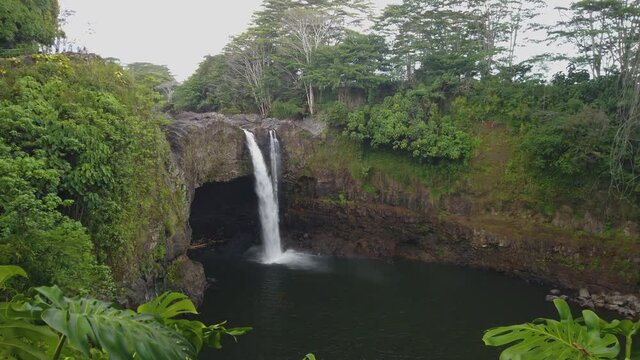 4k right to left panning motion on a sunny day at the touristic Rainbow Falls which is situated not far from the city of Hilo, Big Island,Hawaii,usa