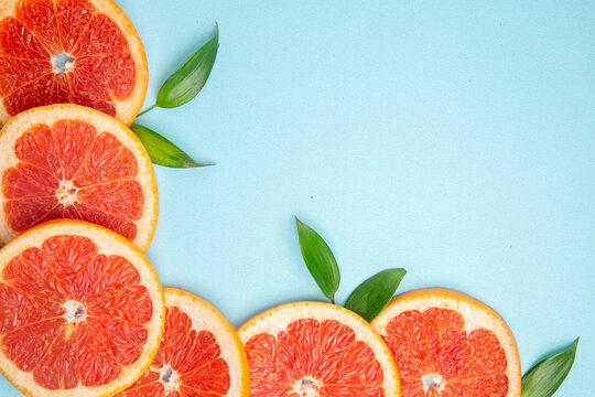 top close view fresh grapefruits fruit slices on blue background fruit citrus fresh juice photo color