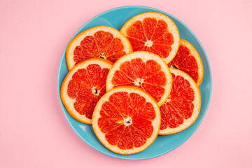 top view tasty grapefruits fruit slices inside plate on pink background fresh citrus fruit juice mellow color diet