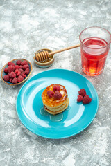 front view tasty muffins with berries and honey on light background sweet taste dough pancake sugar