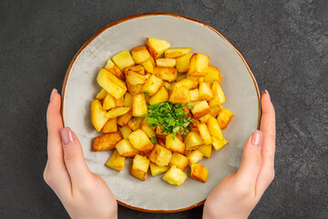 top view tasty fried potatoes inside plate with greens on dark background oil french fries food photo color dinner