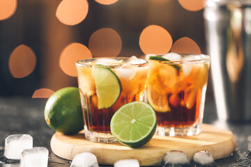 Glasses of tasty Cuba Libre cocktail on table