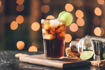 Glass of tasty Cuba Libre cocktail on table