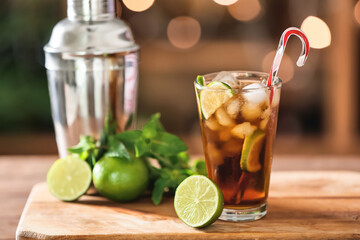 Glass of Cuba Libre cocktail on table