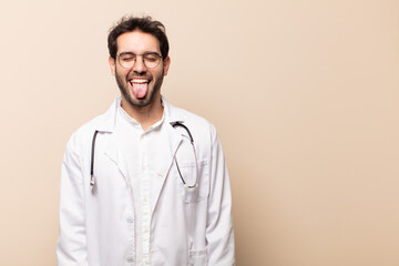 young handsome man with cheerful, carefree, rebellious attitude, joking and sticking tongue out,...
