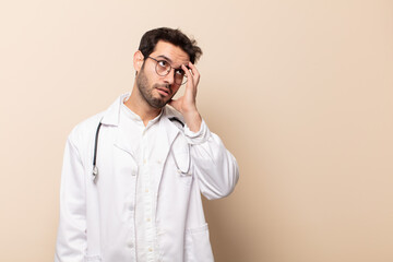 young handsome man feeling bored, frustrated and sleepy after a tiresome, dull and tedious task,...
