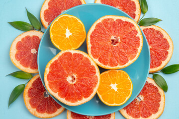 top view tasty grapefruits fruit slices on blue desk fresh citrus fruits juice mellow color