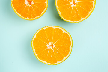 top view fresh tangerine slices lined on a light-blue background photo color fruit orange citrus