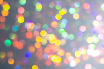 Fototapeta premium Pastel christmas bokeh light backdrop. Blurry holographic background. Bright rainbow neon abstract clipart