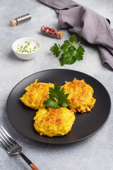 Fried cakes of grated potatoes on the plate with sauce. Traditional pancakes boxty raggmunk.