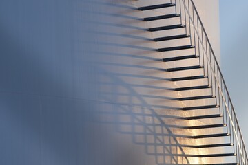Closeup of large oil tank, detail of stairs and railing.  Diagonal and curving shadows of stairs at...