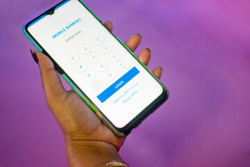 Female hands using mobile banking on white smartphone