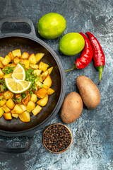 top view tasty fried potatoes with lemon and peppers on light-grey background photo food fry cooking color
