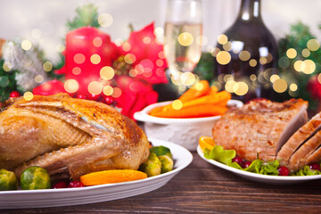 Table served for thanksgiving or Christmas dinner. Stuffed roasted turkey in the foreground. Traditional celebrating holiday.