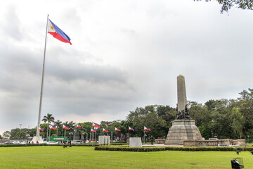 Dr. Jose Rizal National Monument and national flags in the wind, Manila, Philippines, Dec 13, 2020