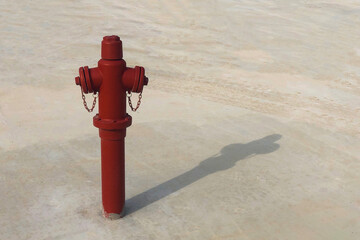 Red fire hydrant with shadow on the ground. Fireman equipment