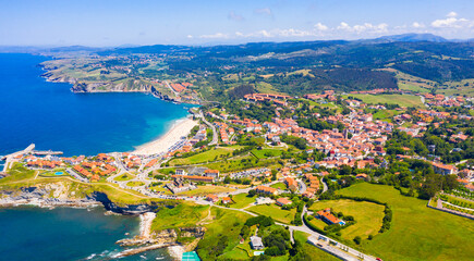 Scenic view from drone of coastal Spanish township of Comillas on sunny summer day, Cantabria