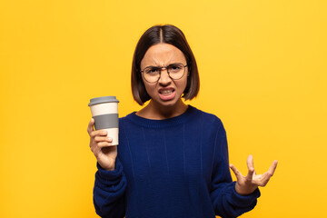 young latin woman looking angry, annoyed and frustrated screaming wtf or what’s wrong with you
