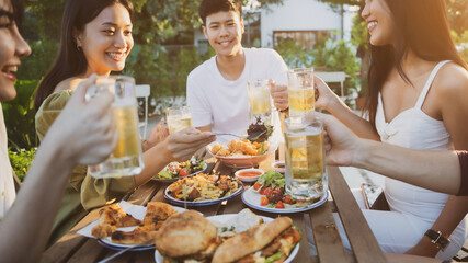 Group holiday party of asian people Eating dinner and drinking beer at home