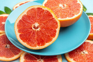 Fototapeta na wymiar front view tasty grapefruits fruit slices on a blue background fresh color citrus fruits juice mellow
