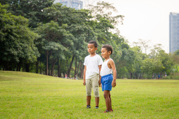 Portrait of two happy kids boys funny playing outdoors in a park, Kids playing concept.