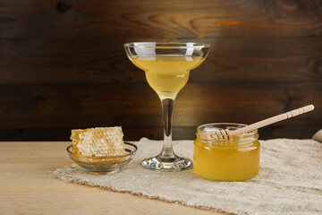 Fototapeta premium jar of honey is on wooden background in rustic style