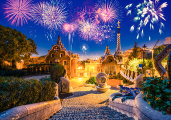 Fireworks show in Barcelona seen from Park Guell. Park was built from 1900 to 1914 and was officially opened as a public park in 1926. In 1984, UNESCO declared the park a World Heritage Site - obrazy, fototapety, plakaty