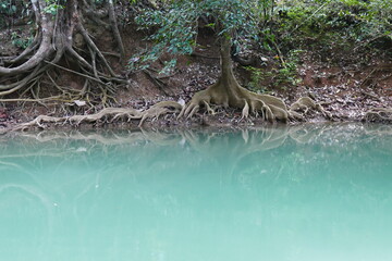 Photo picture of a fascinating view Thailand waterfall and the azure water with colors on the sun
