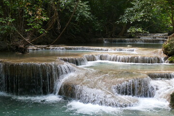 Photo picture of a fascinating view Thailand waterfall and the azure water with colors on the sun