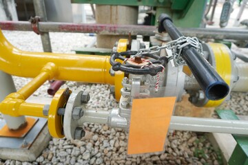Key lock and chain to prevent the valve being opened is part of the Lock out tag out system in oil and gas plant.