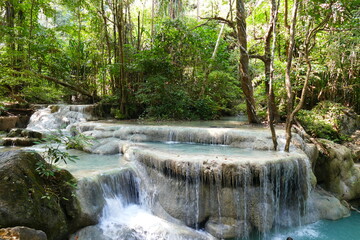 Photo picture of a fascinating view Thailand waterfall and the azure water with colors on the sun