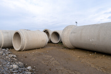 concrete sewage pipes on the ground prepare for underground instalation