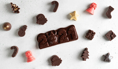 Chocolate bar 2021 with chocolate cow. Chocolate figures pattern.