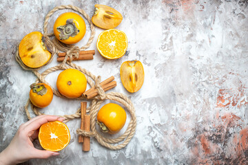 top view fresh persimmons with cinnamon and ropes on light background fruit mellow color photo ripe