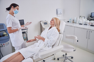 Beautiful Caucasian women talking together in professional beauty center