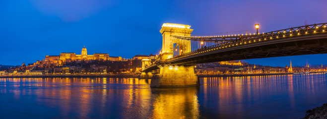 Naklejka premium Blue hour panorama of The Royal palace of Buda castle and the Chain Bridge in Budapest. Hungary
