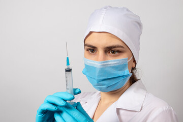The doctor holds a syringe with a vaccine to vaccinate against coronavirus, tuberculosis, diphtheria and rabies. Treatment and prevention of diseases. Nurse and injection