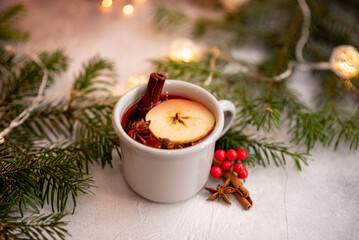 Christmas mulled red wine with aromatic spices and citrus fruits on a wooden rustic table,...
