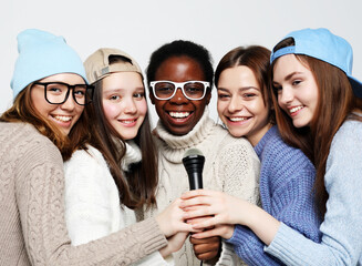 diverse multi nation girls group, teenage friends company cheerful having fun with microphone - Powered by Adobe