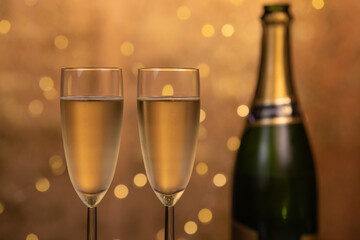 Champagne glasses over holiday bokeh blinking background, rotating on turntable, glasses with sparkling wine, celebration, party. High quality 4k footage