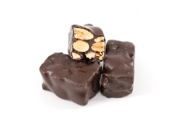 Small pieces of dark chocolate Torrone with almonds on  white background
