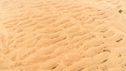 Fototapeta na wymiar yellow sand by the sea as background