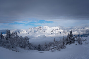 snowy mountain panorama with partly cloudy blue sky