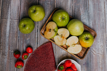 Strawberry fruit leather with fresh fruits on the wooden table. Round fruit leather. Healthy food. Apples, bananas, strawberries top view.