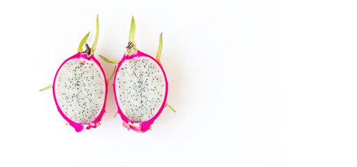 Halves of delicious ripe dragon fruit pitahaya on white background, top view