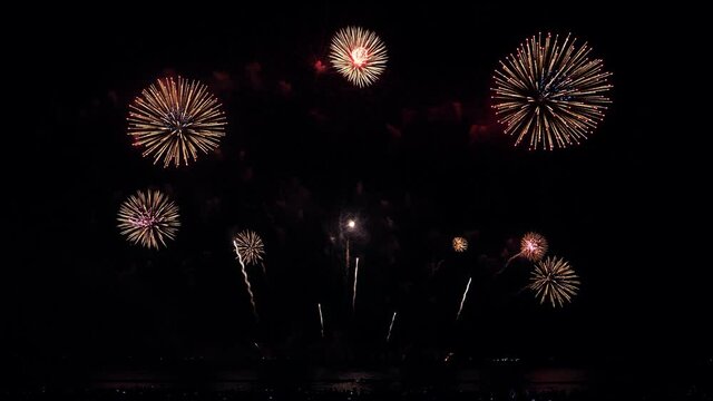 4K. 
Colorful Happy holiday fireworks on the beach background. Abstract real golden shining fireworks with bokeh lights in the night time. 
New year's eve real fireworks celebration.