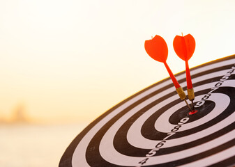 Dart arrow hit to center on bullseye(bull's-eye) of a dartboard is a target of purpose challenge...