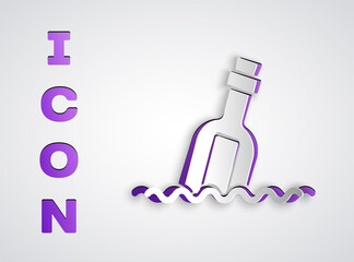 Paper cut Glass bottle with a message in water icon isolated on grey background. Letter in the bottle. Pirates symbol. Paper art style. Vector.