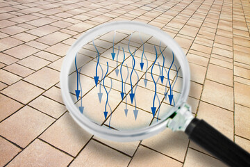 Focus on infiltrations of water on a terrace roof - Concept image with a stone pavement seen through a magnifying glass